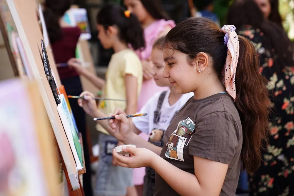 A group painting outdoors