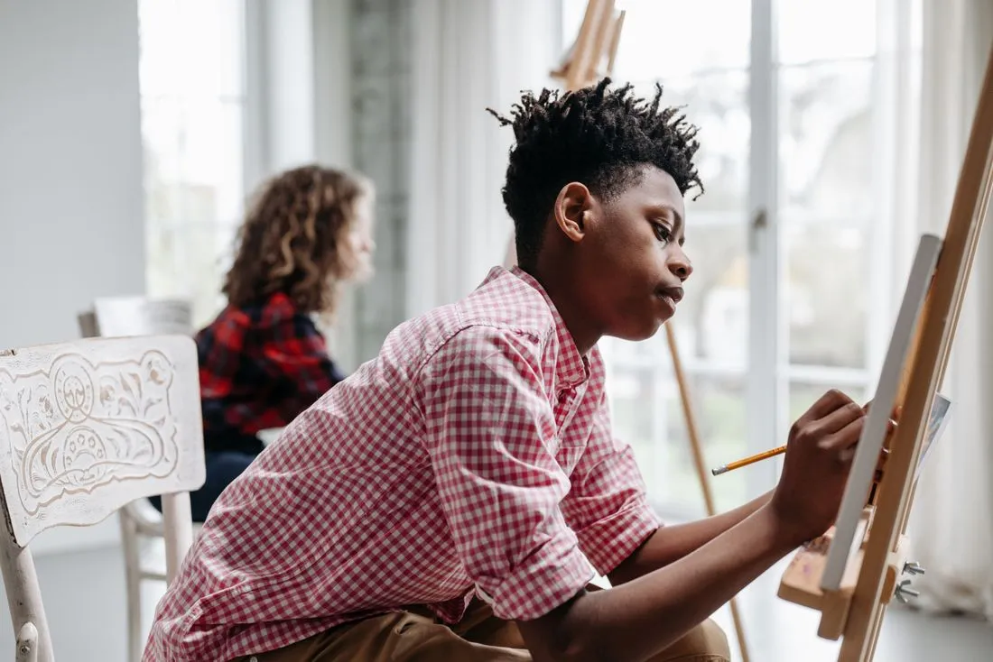 Young people painting in an art class
